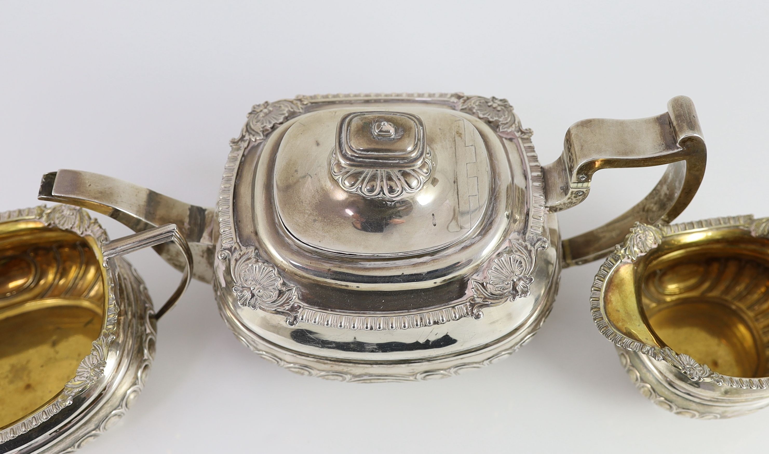 A George III Scottish silver demi-fluted three piece tea set by George Fenwick